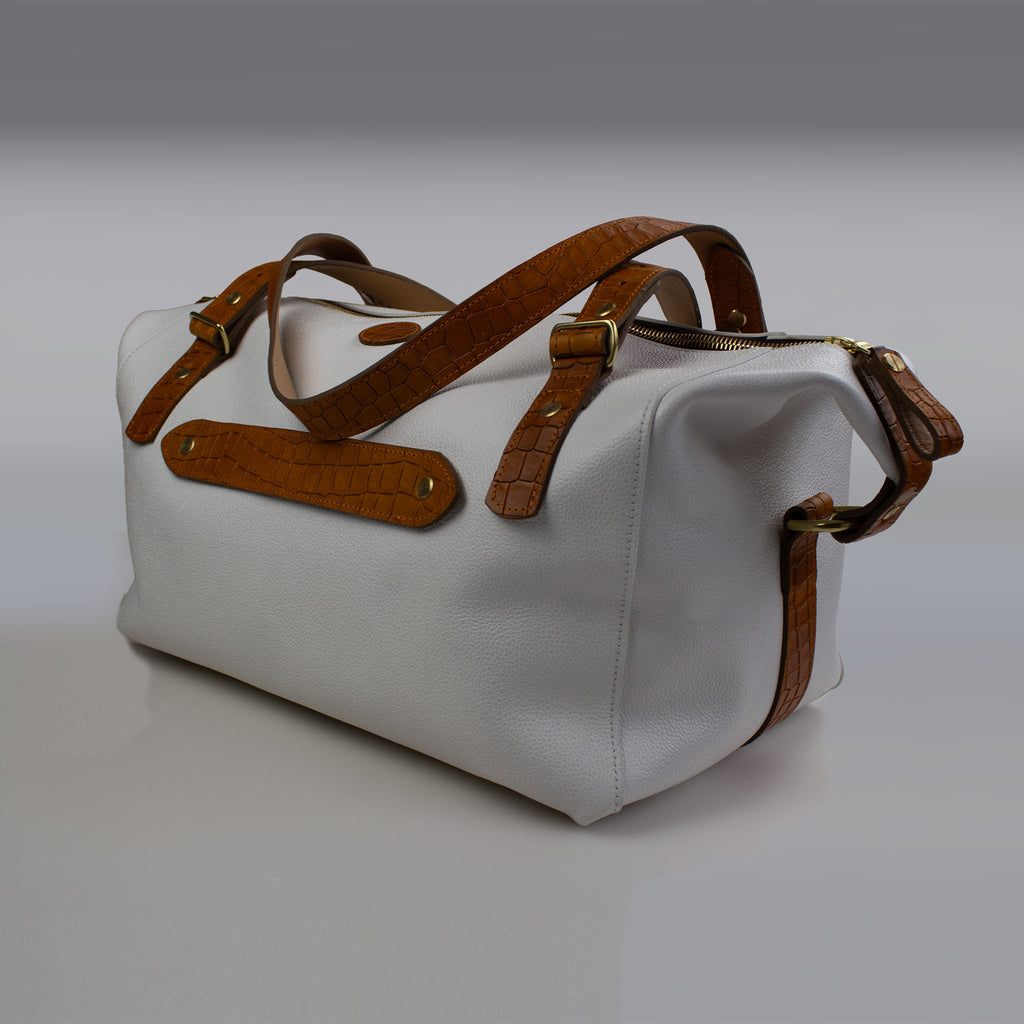 Rear of white luggage bag long handles in tan showing luggage stramade in by Sam-Brown-London in Devon England 