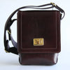 Brown leather crossbody bag with a gold clasp on a white background