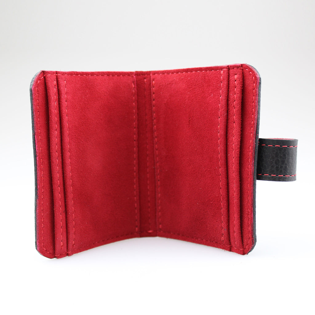 Elegant Black leather card wallet to keep cards secure. Hand-crafted from British full-grain leather,  two-toned for striking effect. Hardware in nickel Lined in soft red leather made by Sam Brown London Wiltshire UK