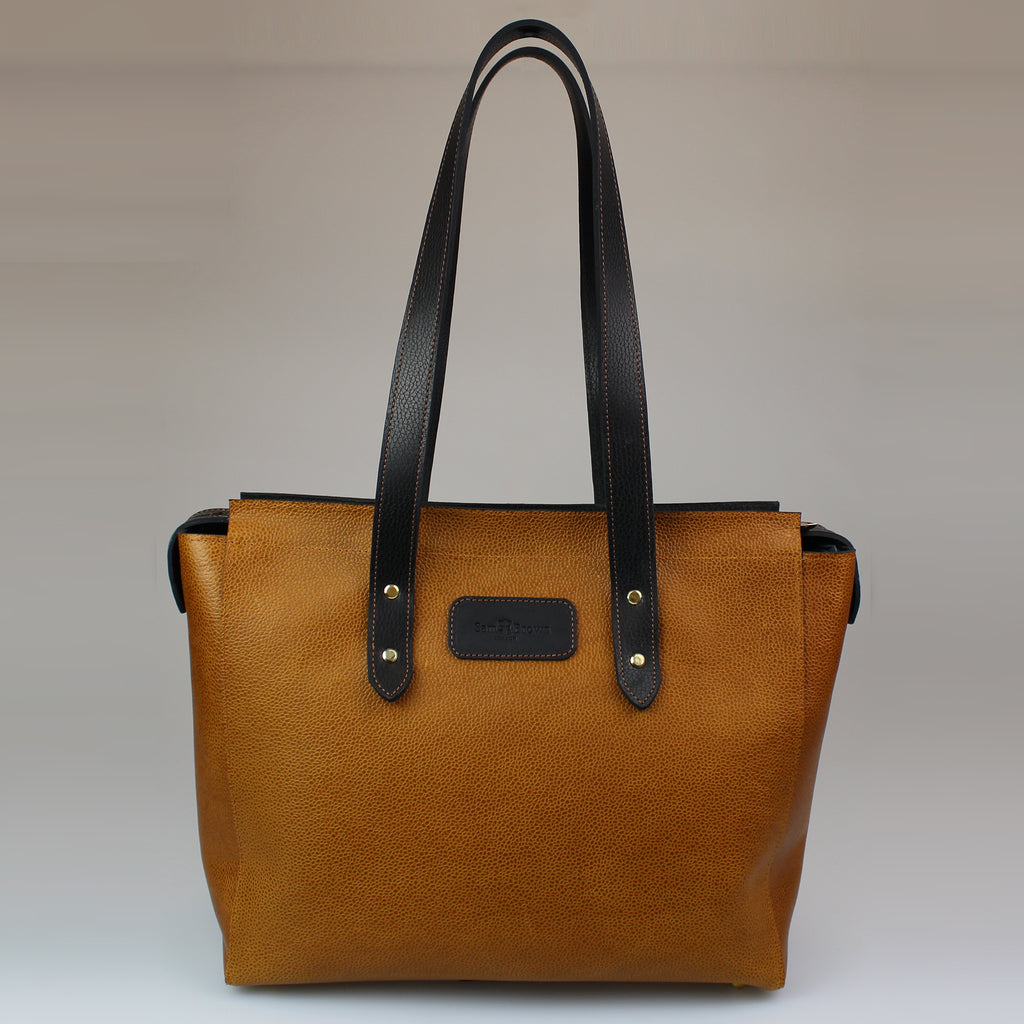 Classic Brown Tote Bag-Grained calfskin Harris Tweed lining Brass fixings  Tan leather handles  Full length top zip Internal leather pocket with zip Made in England, UK