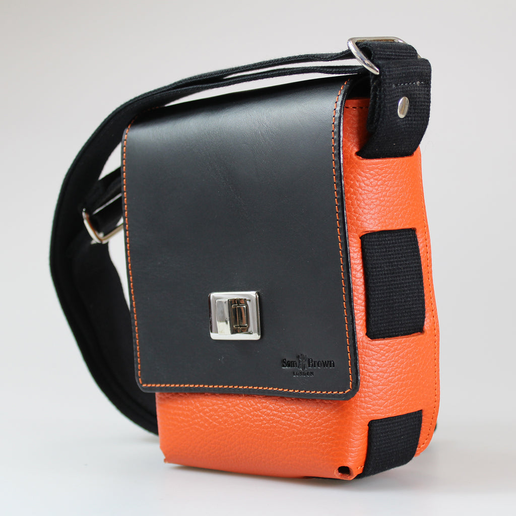 Side view showing black-100%-cotton-british-webbing-The-compact-traveller-bag orange-hermes-leather with black-bridle-leather with nickel-fixings-made-by-Sam-Brown-London England 