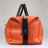 side-view-of-Sam-Brown-London-orange-leather-with-black-handles -and-trim-weekend-luggage-bag