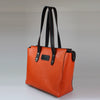 side-view_Striking_orange-grain_calfskin_large_tote_bag_black_smooth_leather_handles