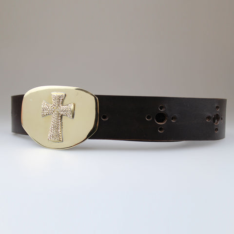 Encrusted champagne crystal cross on solid brass buckle with brown hole punched leather strap. 
